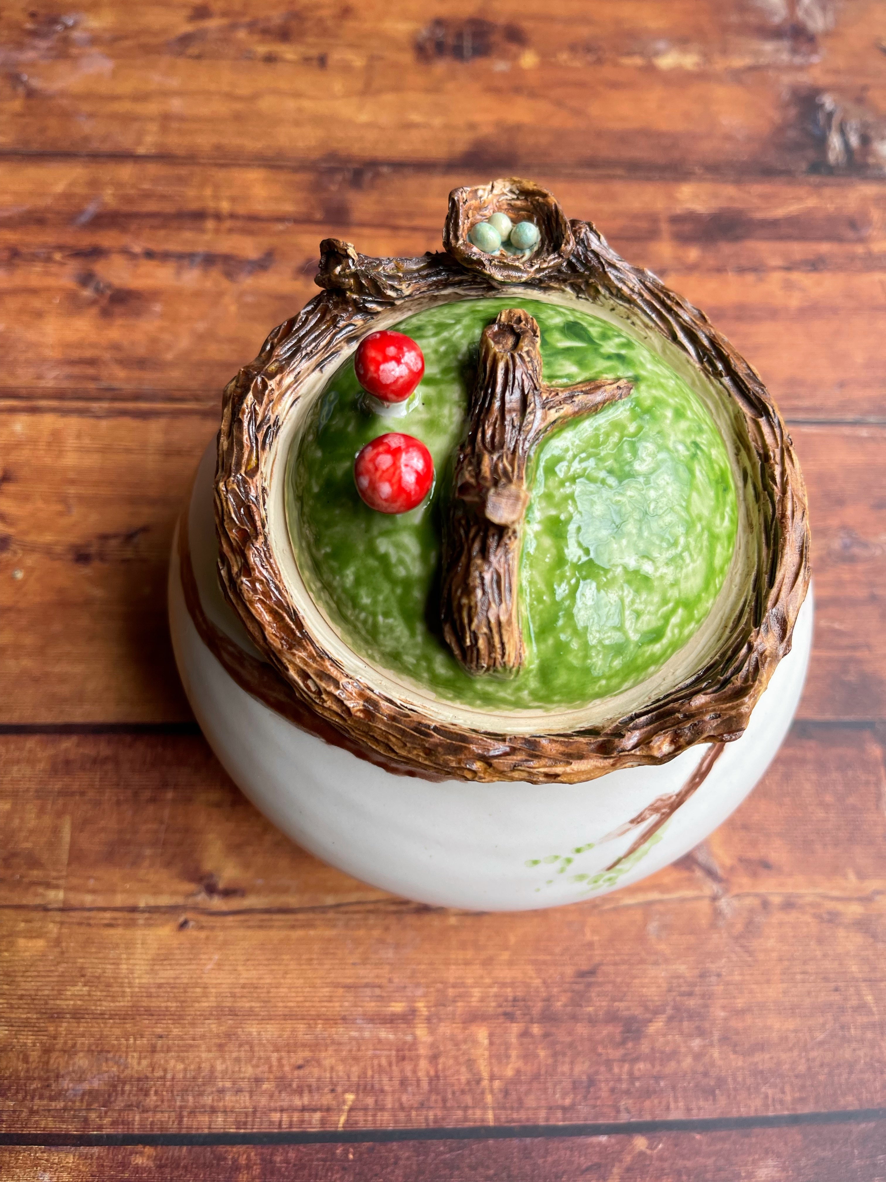 Handmade ceramic jar with birds nest