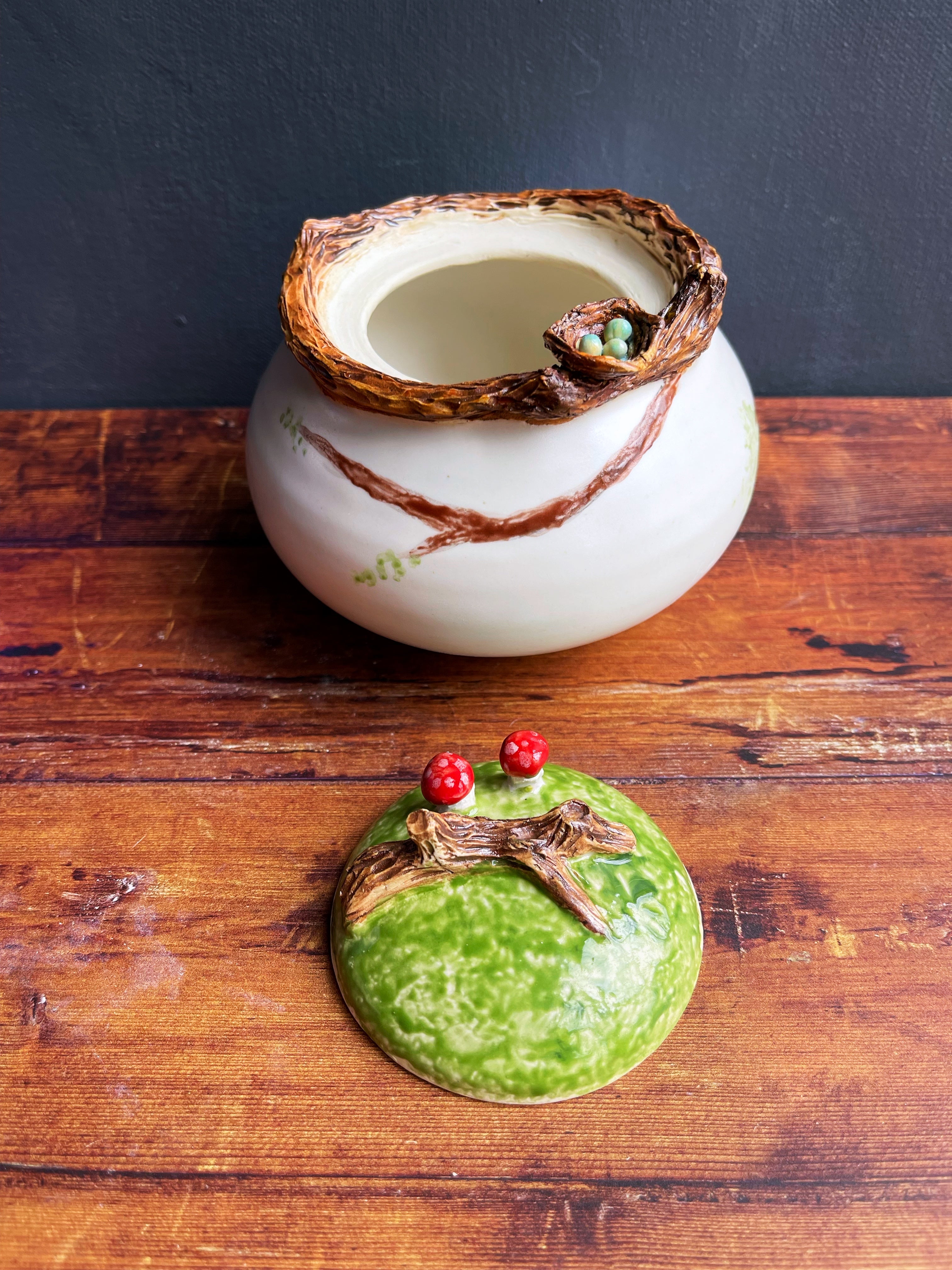 Handmade ceramic jar with birds nest and mushrooms 