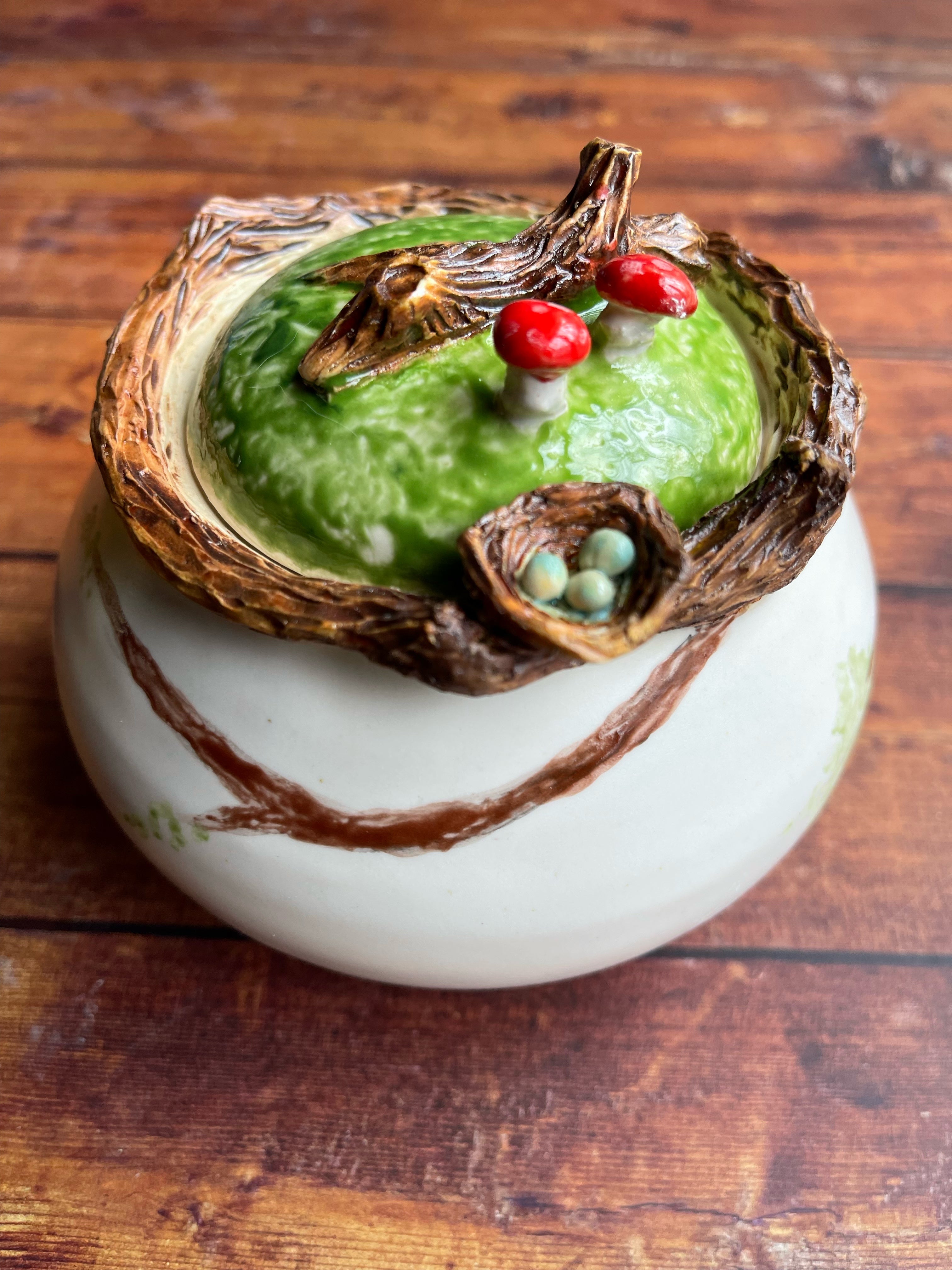 Handmade ceramic jar with birds nest